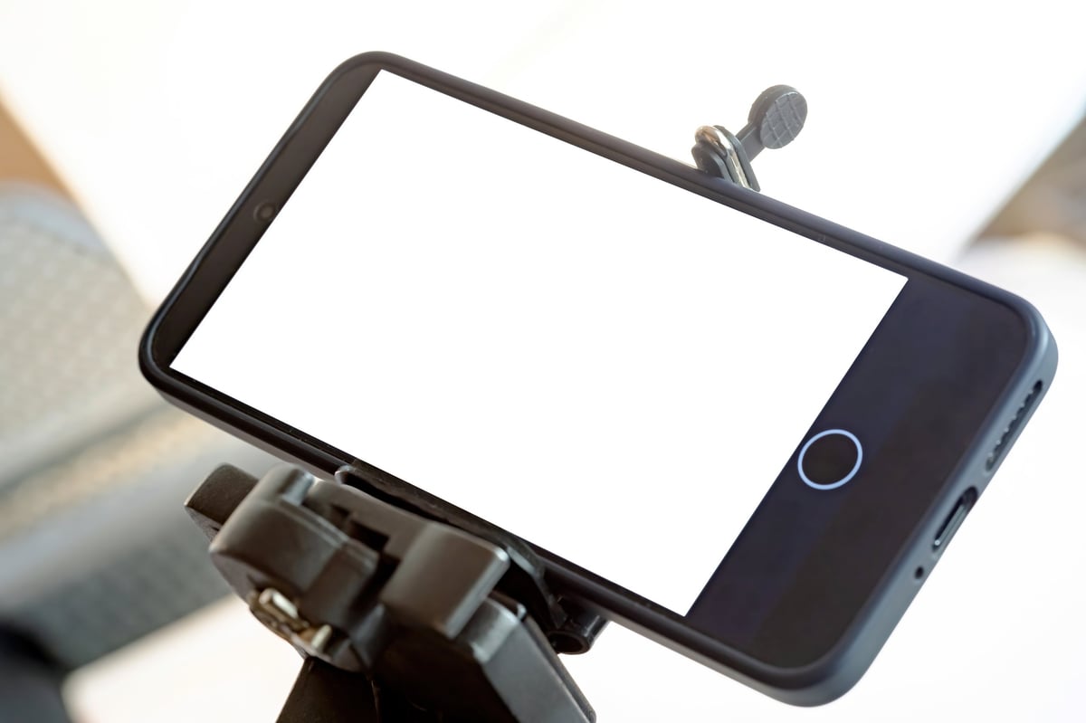 A smartphone mounted on a tripod with a blank screen, representing fast retrieval of a Proof Guard evidence record